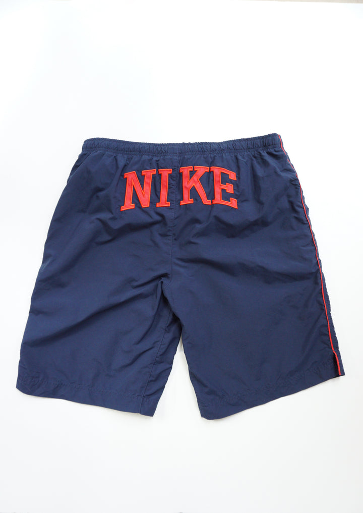 Nike navy blue swim shorts with red embroidered text on the back and mesh lining