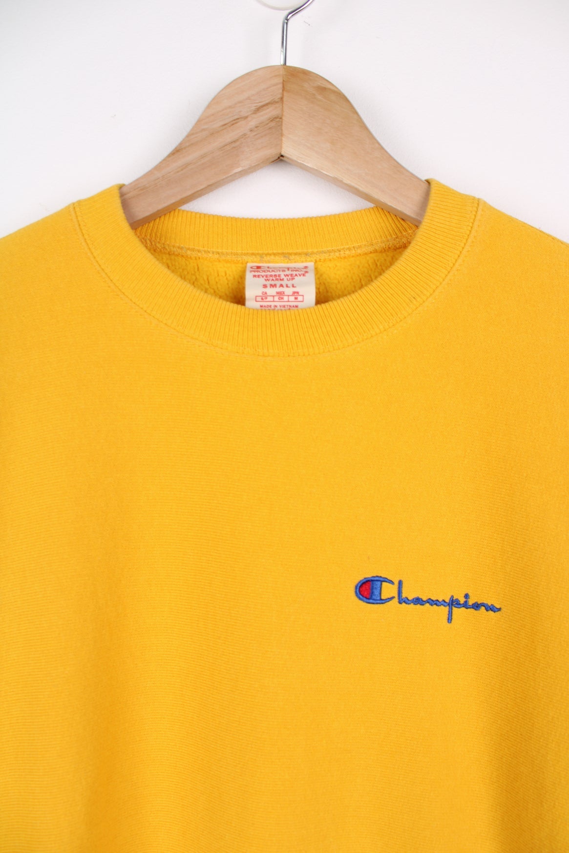 Champion Reverse Weave sweatshirt in yellow. Features embroidered logo on the chest.