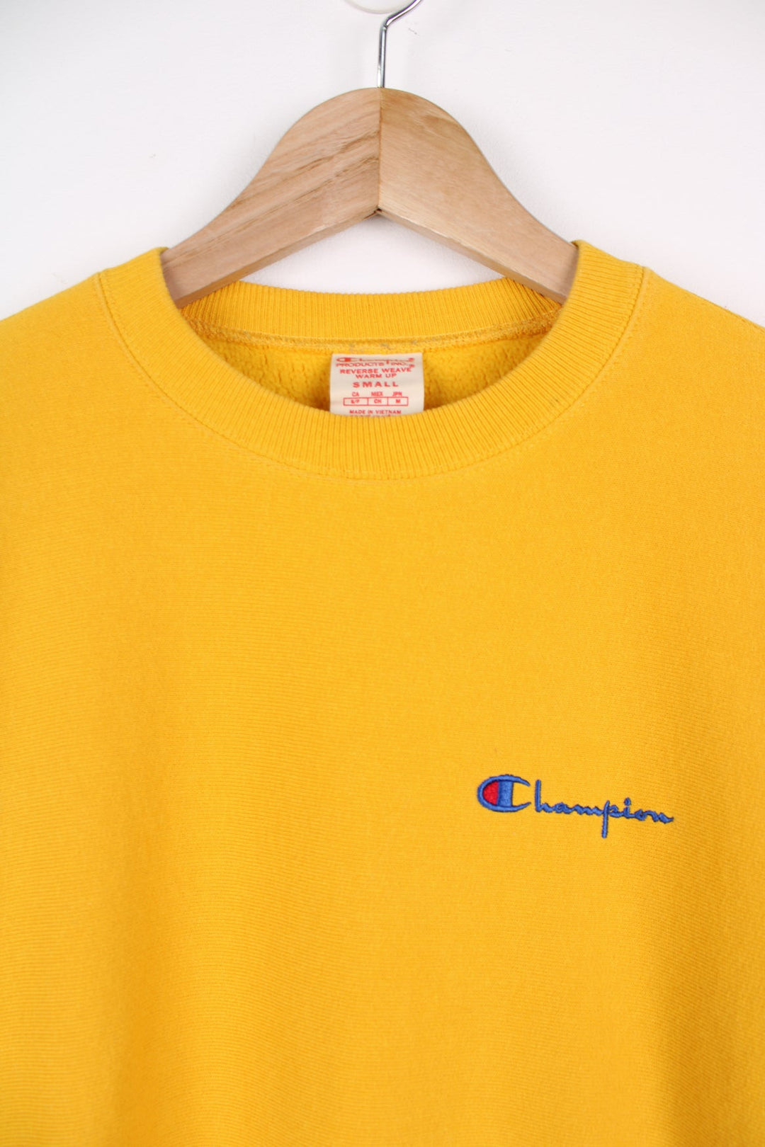 Champion Reverse Weave sweatshirt in yellow. Features embroidered logo on the chest.