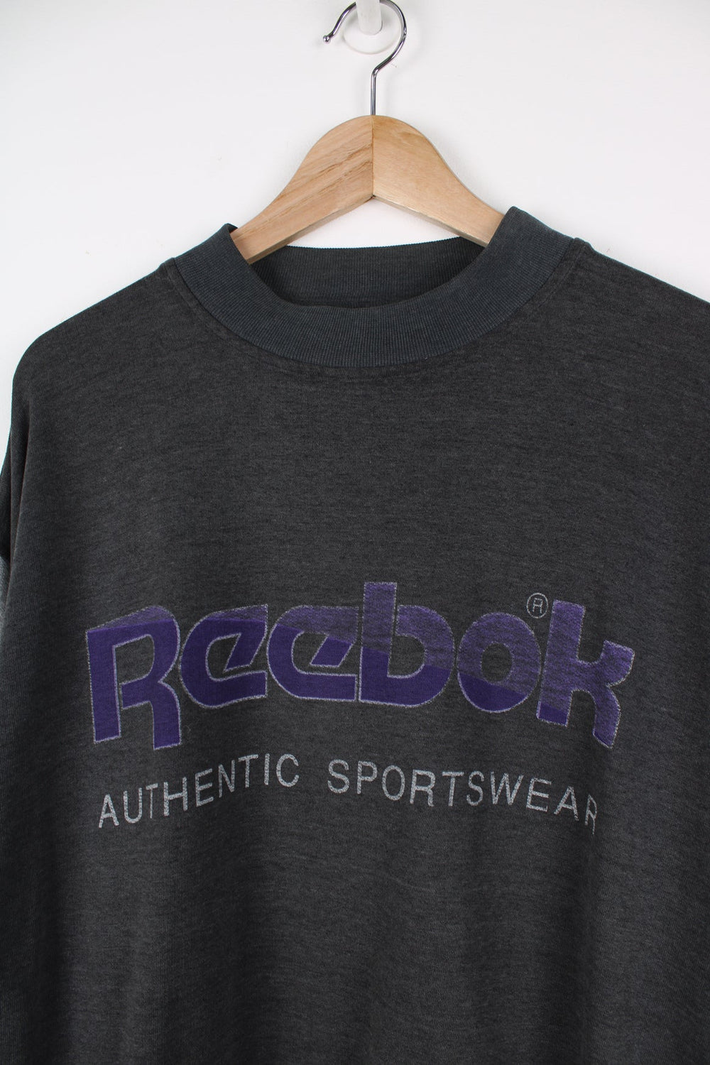 Vintage Reebok sweatshirt with printed logo across the chest in purple.