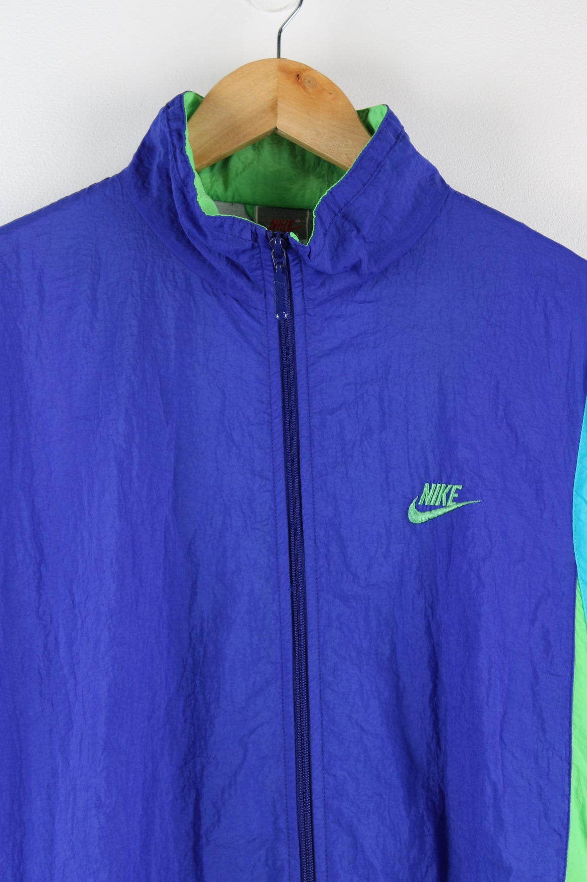 Vintage Nike shell jacket in purple, blue and green. Features embroidered logo on the chest.